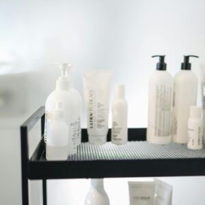 Aesthetic display of skincare products arranged on a two-tiered cart in a salon.